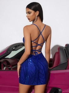 Detail of the royal blue sequin dress featuring cross-back straps and an open-back design