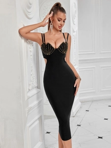 Detail of shell-shaped bust with gold rivets and cutout on a black bandage dress