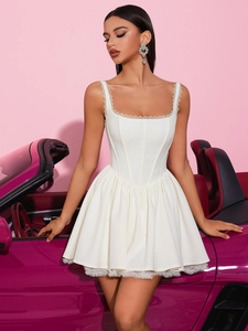 Detail of white lace square neck dress with corset waist beside a classic purple convertible