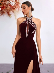 Detailed view of rhinestone neckline and hollow chest on a burgundy velvet formal dress