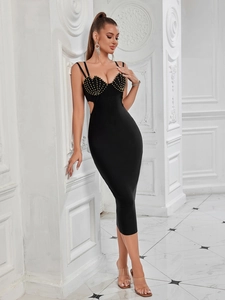 Close-up of black bodycon bandage dress with golden studs and side cutout detail