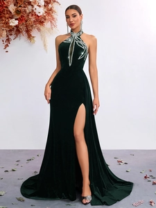 Detail of emerald velvet gown showing halter neck cutout and luxury rhinestone patterns