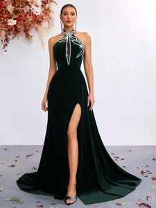 Detail of emerald green velvet evening dress with halter neck and sparkling rhinestone beads