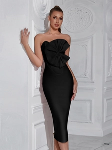 Detailed view of black strapless midi dress featuring a large structural bow on the bust