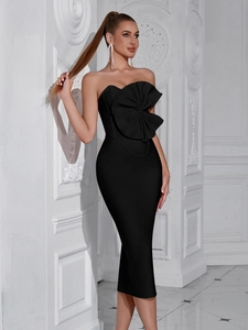 Close-up of elegant black strapless bandage dress with oversized mesh bow detail