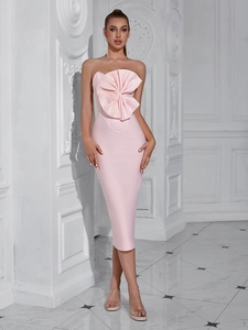 Detail of light pink strapless midi dress featuring a large 3D bow decoration on chest