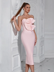 Detail showing the pink strapless bandage evening gown with a large decorative bow design
