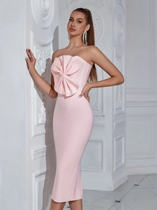 Pink strapless tube bandage dress featuring an oversized bow detail and fishtail silhouette