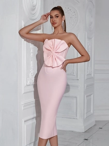 Elegant pink strapless bandage dress featuring a large sculptural floral bow accent