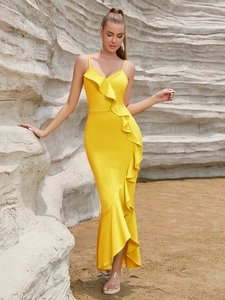 Detail of vibrant yellow one-shoulder evening dress with layered ruffle accents and fishtail hem