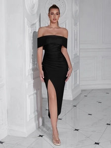 Detail of off-shoulder black dress featuring ruched fabric and a high side leg slit