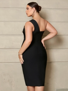 Detail view of the one shoulder black bandage dress with elegant gold button accents
