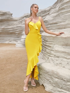 Detail view of the elegant bright yellow ruffled shoulder and slim fishtail hemline
