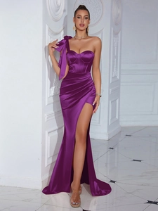 Detail view of purple satin one-shoulder evening gown with large bow and high slit