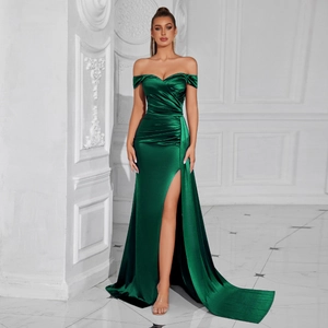 Detail of the elegant dark green satin off-shoulder dress with high slit and long train