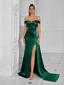 Detail of emerald green satin dress featuring pleated tube top and high side slit design