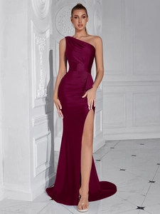 Detail of burgundy one-shoulder satin dress featuring elegant waist pleats and a high slit