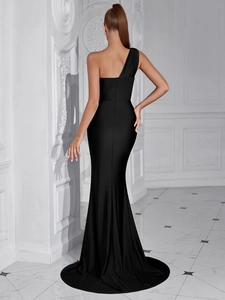 Detail of elegant black one-shoulder evening gown with fishtail hem and slim fit back