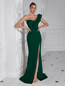 Detail of elegant dark green one-shoulder evening gown with ruffles and a high side slit