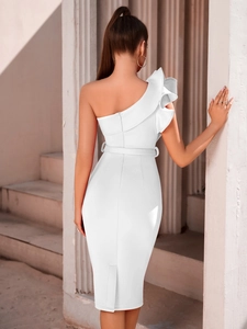 Close-up of elegant ruffled shoulder detail and back zipper on white midi dress