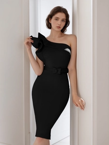 Detail of the ruffle shoulder design and waist belt on a black one-shoulder party dress