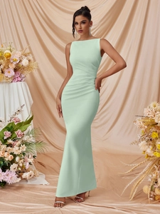 Detail of mint green sleeveless dress with elegant ruched waist and fisheye hemline