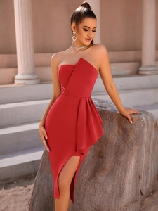 Detail of red off-shoulder dress featuring geometric layering and a side ruffle accent