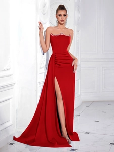 Close-up of elegant red strapless satin gown featuring sparkling rhinestone trim on neckline