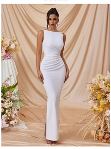 Detail view of white sleeveless maxi dress featuring elegant side slit and ruched waist details