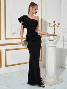 Detail view of black one-shoulder evening gown with ruffled sleeve and sparkling rhinestone waist