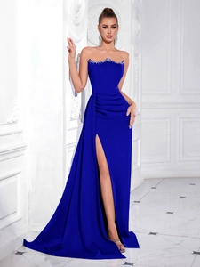 Detail of royal blue strapless evening gown with sparkling crystal trim and high slit cut