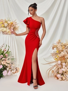 Detail of red one-shoulder evening gown featuring diamond embroidery and high side slit