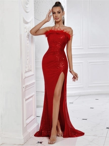 Detailed shot of red sequin evening gown featuring feather neckline and side slit design