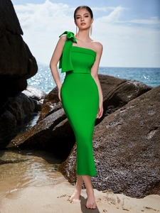 Detail of elegant one-shoulder green evening dress with large bow knot and slim silhouette