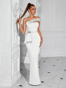 Detail of white evening gown featuring rhinestone floral buckle and satin patchwork collar