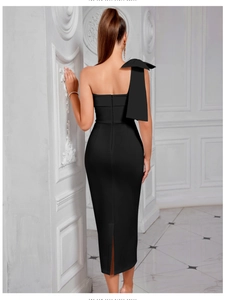 Detail of elegant black one-shoulder dress with large bow and back slit design