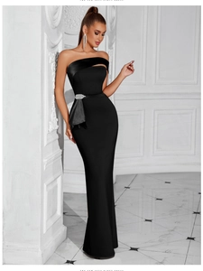 Detailed view of luxury rhinestone waist decoration on elegant black strapless evening dress