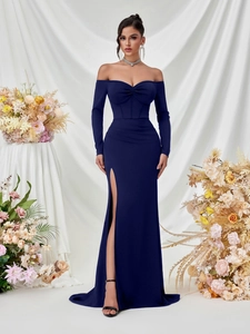 Detail of elegant navy blue long-sleeved evening gown with high slit and draped neckline