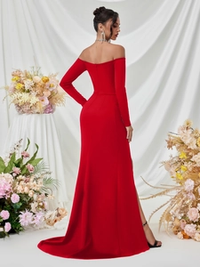 Detail of elegant red floor-length gown with off-shoulder cut and long sweeping train