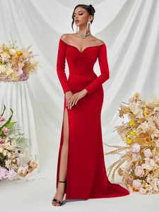 Detail of the elegant red off-shoulder floor-length gown with high slit and ruched bodice