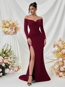 Detail of burgundy off-shoulder evening gown with ruched chest and thigh-high slit
