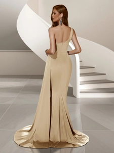 Detailed back view of a champagne satin mermaid evening gown with backless design