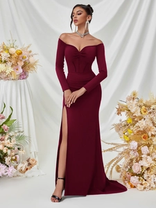 Detail of elegant burgundy off-shoulder floor-length gown with ruched neckline and high slit