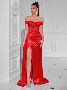 Detail of red off-shoulder evening gown featuring elegant ruched waist and high slit design