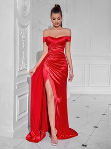 Detail of red off-shoulder satin gown with elegant waist pleats and high slit hemline