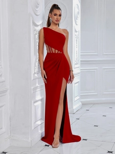 Detail of red one-shoulder evening gown featuring waist cutout and high slit design