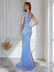Detailed view of shimmering light blue sequins and ruffled shoulder on a mermaid gown