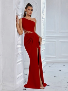 Detail of red one-shoulder evening gown featuring waist cutout and high leg slit