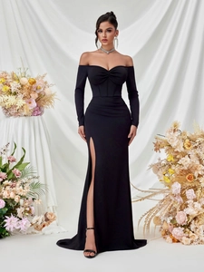 Detail of elegant black off-shoulder evening dress featuring side slit and corset bodice