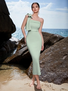 Elegant mint green one-shoulder evening dress with a large bow detail and slim fit cut